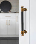 Close-up of 10 Pack 5 Inch Black And Antique Brass Kitchen Cabinet Handles Knurled Cabinet Pulls on white cabinet door