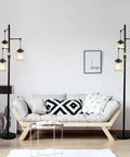 Industrial Farmhouse Floor Lamp With Three Glass Shades, Tall Standing Lamp With Dimmable Switch, Sturdy Black Base For Living Room Bedroom Office Home Decor, Modern Rustic Lighting That Hits next to a modern sofa