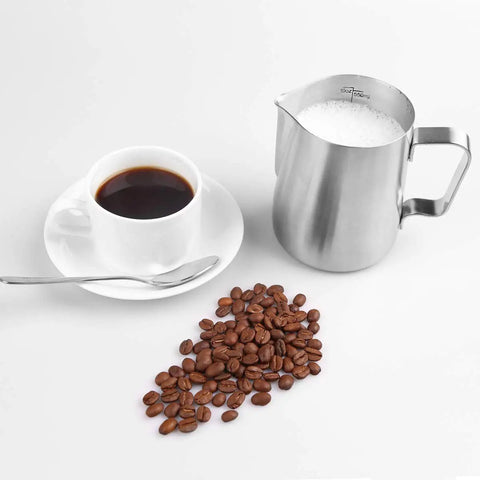 Milk Frothing Pitcher 12oz And 20oz Stainless Steel Jug For Espresso Machines And Latte Art beside a coffee cup and beans