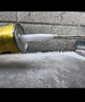 Heavy Duty Grey Semi Self Leveling Sealant Two Pack dispensing from tube onto a surface, showing flexibility and moisture resistance.