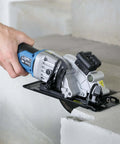 G LAXIA cordless mini circular saw, blue, with laser guide, 4-1/2-inch blade cutting concrete.
