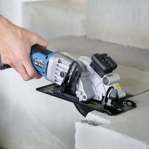 G LAXIA cordless mini circular saw, blue, with laser guide, 4-1/2-inch blade cutting concrete.