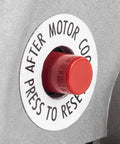 Air compressor motor red reset push-button on metal housing.