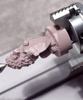 Close-up of Next Level Rotary Module For Your Desktop Maker Machine carving detailed lion figure with 3 jaw chuck.