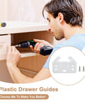 Man installing Top Shelf Bottom Mount Drawer Slide Guides 12 Pack Plastic Track Rails in a cabinet with drill.