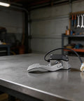 Heavy Duty Metal Throttle Foot Pedal For Golf Cart And Electric Vehicle on a workbench, showcasing IP55 waterproof seal and sturdy design.