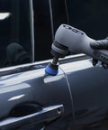 Person using Top Shelf Blue High Cut Foam Buffing Pads To Sweep Nasty Swirls Away From Your Ride Fits Any Random Orbital Polisher on car door.