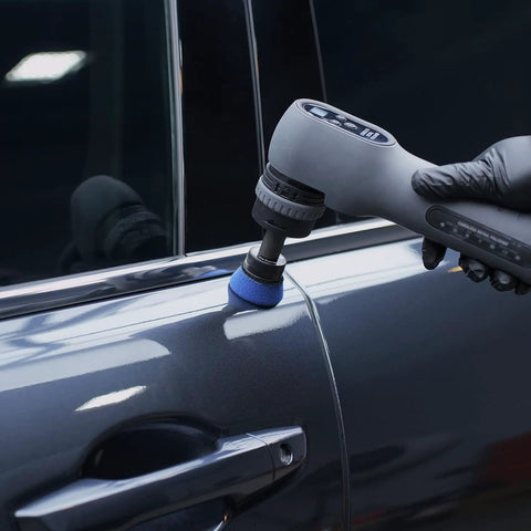 Person using Top Shelf Blue High Cut Foam Buffing Pads To Sweep Nasty Swirls Away From Your Ride Fits Any Random Orbital Polisher on car door.