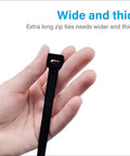 Hand holding Beefy Heavy Duty Outdoor Zip Ties 48 Inch Long 175 Pound Tensile Strength 12 Pack Premium Black PA66 Nylon Weatherproof Cable Tie.