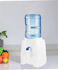Portable Cold Water Dispenser For Countertop Space Saving Mini Water Cooler with blue bottle in kitchen setting
