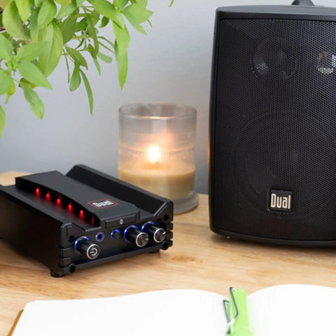 Micro 2 Channel Class D Amplifier With 3.5mm AUX Input And Stereo RCA Outputs 100W Peak Power Long Range Bluetooth next to speaker