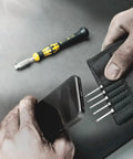 Hands using Kraftform Kompakt ESD 11 Piece Micro Tool Set For Precision Mechanics with smartphone and tool bits visible.