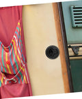 Black flush-pull slam latch on boat cabin wall with a round recessed handle.