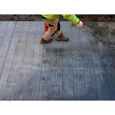 Worker applying Heavy Duty Solvent Based Acrylic Concrete Sealer Boasting Rock Solid High Gloss Finish on stamped masonry.
