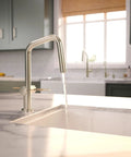 hansgrohe Talis N Pull Down Kitchen Faucet, Modern, Magnetic Hand Sprayer, 1-Handle, 1.75 GPM, Polished Nickel pouring water into a white sink.