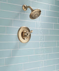 Linden 14 Series Shower Trim Kit With 5 Spray Touch Clean Shower Head in Venetian Bronze installed on blue tile wall.