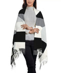 Black And White Piano Grid Winter Scarf Crafted From Plush Faux Cashmere With Extended Fringe Edges worn over a light sweater.