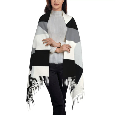 Black And White Piano Grid Winter Scarf Crafted From Plush Faux Cashmere With Extended Fringe Edges worn over a light sweater.