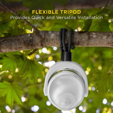 Portable LED Motion Sensor Light With 148 Lumens, flexible tripod base hanging on a tree branch for outdoor use