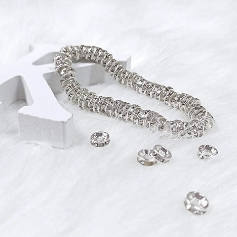 Stack of 200 Pcs Crystal Rondelle Spacer Beads 8mm Silver Plated for jewelry making on fluffy surface with a star decor