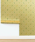 Level Up Your Interiors With This Stunning Cottage Floral Gold Metallic Wallpaper Showcasing Rich Fibrous Texture And Effortless Paste Application For Ultimate Room Refresh Vibes, showing green floral patterns on gold background.