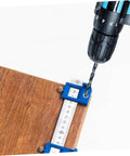 Adjustable Punching Tool For Woodworking Jig For Cabinet Handles installed on wood with drill bit in action
