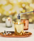 Bad Boy Stainless Steel Candle Snuffer With Super Long Handle And Slick Silver Plating extinguishing a gold candle flame.