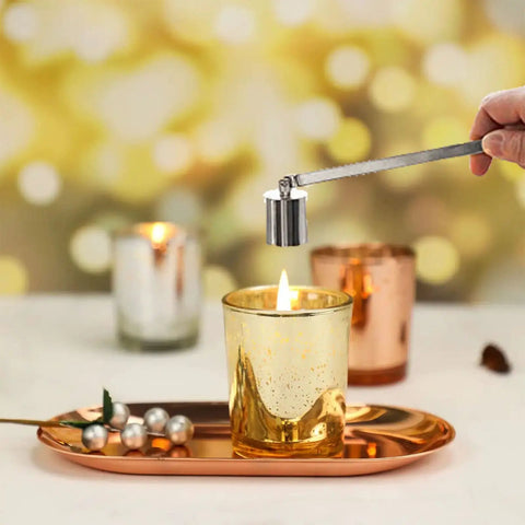 Bad Boy Stainless Steel Candle Snuffer With Super Long Handle And Slick Silver Plating extinguishing a gold candle flame.