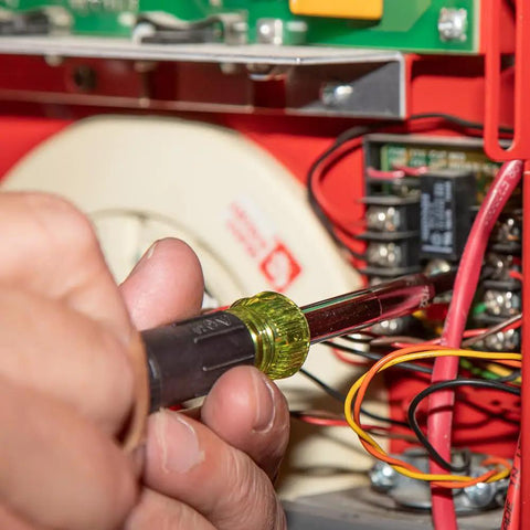 Close-up of 14-In-1 Electronic Precision Screwdriver Kit With 8 Tips Slotted Phillips And Tamperproof Torx Bits in use on electronics