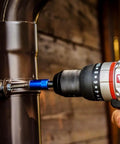 User operates Brushless Cordless Hammer Drill With Two 20 Volt Batteries And Active Hammer Action for fastening on metal pipe.