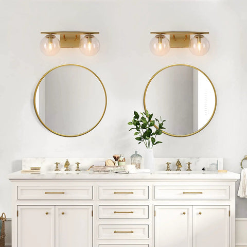 Gold Vanity Light 2-Light Fixture With Globe Clear Glass Shades For Bathroom, 16 Inch Length, shown above double sinks.