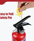 Hand holding yellow safety pin of 2.5 Lb ABC Dry Chemical Fire Extinguisher With Bracket And Quick Release Handle.