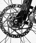 High Quality Mechanical Disc Brake Set For Mountain Bike Featuring Front And Rear Aluminum Alloy Calipers With Killer Stopping Power And Street Tough Build Quality That Lets You Shred Trails Without A Care While Rolling Smooth, close-up of front brake rotor and caliper.