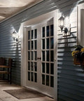 Coastal White Outdoor Wall Light With Clear Beveled Glass 17 Inch Tall 1 Light Exterior Porch Lantern on blue siding by door