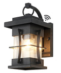 Ultra Durable Dusk To Dawn Outdoor Wall Light in black finish with seeded glass shade, IP65 waterproof, mounted on a wall.