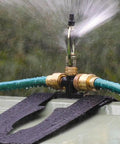 Heavy Duty 360 Degree Rotating Rooftop Sprinkler For Backyard Boss Lawn Cooling And Garden Watering With Smooth Sweep Adjustment And Built Different Zinc Frame spray nozzle in action with water mist.