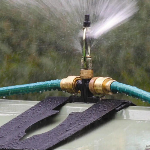 Heavy Duty 360 Degree Rotating Rooftop Sprinkler For Backyard Boss Lawn Cooling And Garden Watering With Smooth Sweep Adjustment And Built Different Zinc Frame spray nozzle in action with water mist.