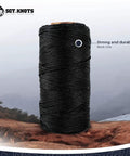 Tarred Nylon Bank Line Twine For Bushcraft And Outdoor Projects, weatherproof black lacing cord spool on rocky terrain