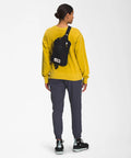 Person wearing Berkeley Field Bag Water Repellent Finish Vintage Style Travel Essential Sling over shoulder, back view.