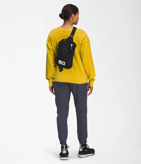 Person wearing Berkeley Field Bag Water Repellent Finish Vintage Style Travel Essential Sling over shoulder, back view.