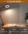 Clip On LED Desk Lamp with Flexible Arm 3 Color Modes and 10 Brightness Levels on desk showing warm yellow light.