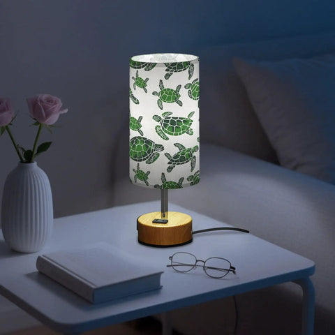 Green Watercolor Turtle Decor Bedside Table Lamp With 3 Way Dimming Touch Built In Charging Station For Nightstand Or Desk USB C Port USB Port 2 Pin Outlet LED Bulb Included on a nightstand with book and glasses