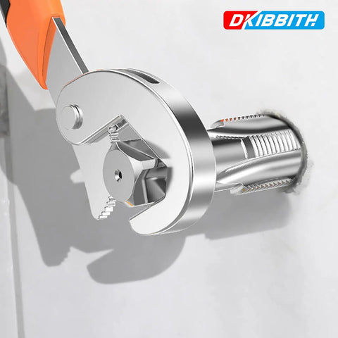 Adjustable wrench being used on a metal pipe fitting in a plumbing installation with a visible brand logo