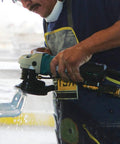 Worker using 4 Inch Electronic Stone Polisher with Variable Speed Control, Soft Start, and Constant Speed Under Load on stone surface