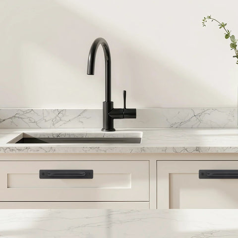 4 Pack Black Zinc Alloy Barn Door Handles Set installed on white kitchen cabinets below black faucet.
