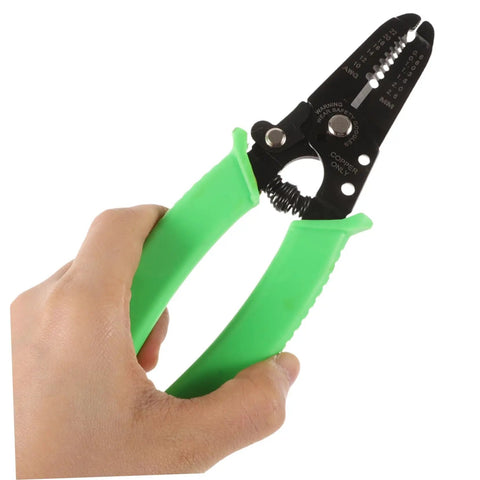 Portable Wire Stripper Pliers With Soft Grips Rapidly Strips Copper Jacketing held in hand with green grips.