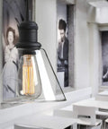 Retro Edison Style Pendant Light With Clear Glass Shade For Kitchen Island Dining Room Classic Retro Vibe Industrial Black Mini Flush Mount Fixture E26 Base 40W Bulb Not Included Ideal For Living Room Bathroom Porch Bar Hotels hanging in a dining area with black-and-white decor.