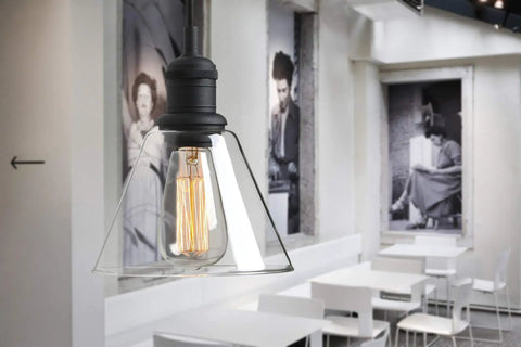 Retro Edison Style Pendant Light With Clear Glass Shade For Kitchen Island Dining Room Classic Retro Vibe Industrial Black Mini Flush Mount Fixture E26 Base 40W Bulb Not Included Ideal For Living Room Bathroom Porch Bar Hotels hanging in a dining area with black-and-white decor.