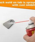 Spraying rust inhibitor on Heavy Duty Weld On Tabs For One Half Inch Holes, Steel Shock Mount Weld Tabs, One Quarter Inch Thick