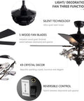 Crystal Ceiling Fan With Light And Remote Features Five Reversible Wood Blades To Deliver Buttery Smooth Airflow And Bring Major Chill To Every Home Space, showing black fan with crystal decor and switches.